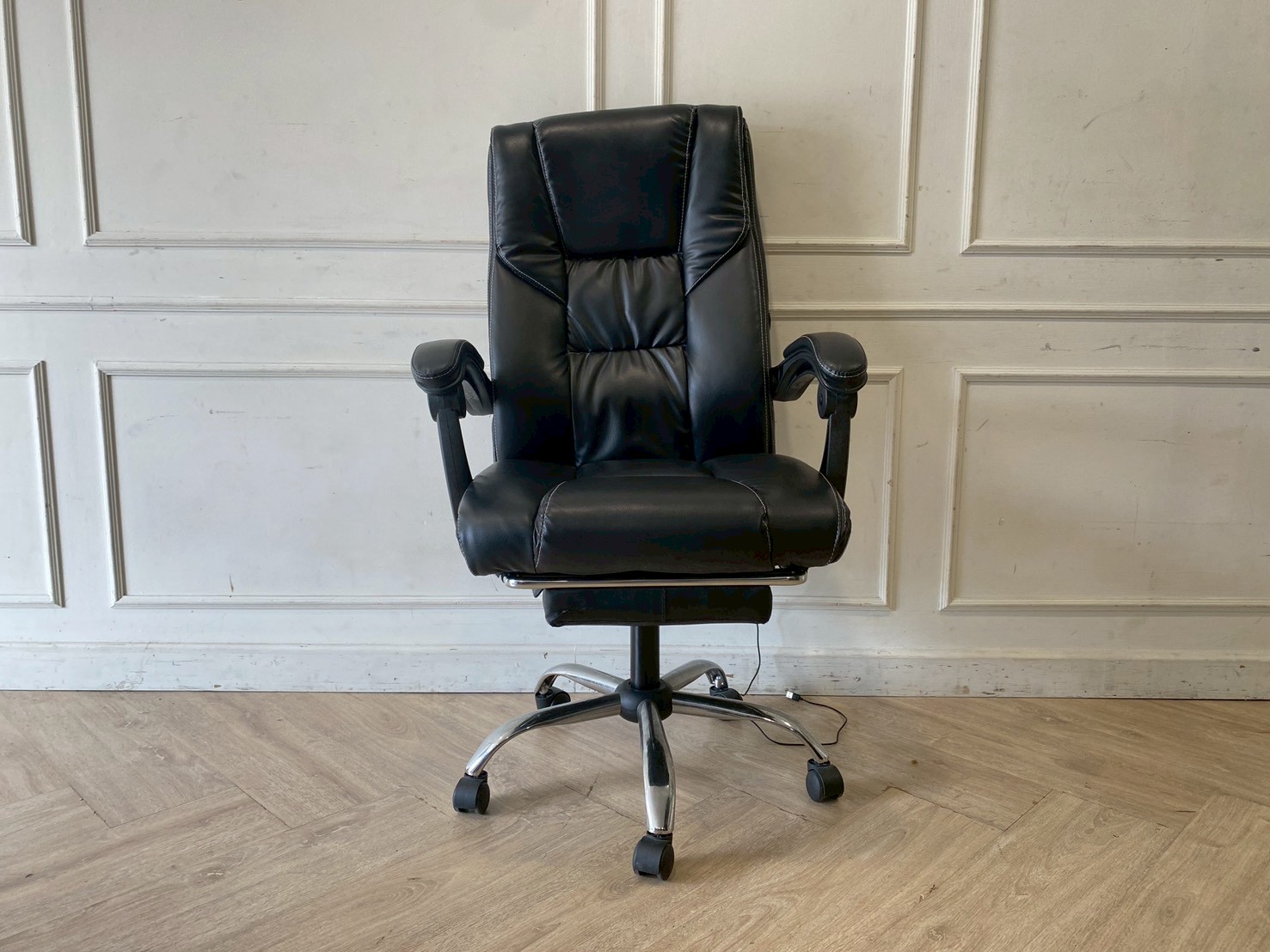 Office chair with massage function, black leather upholstery.