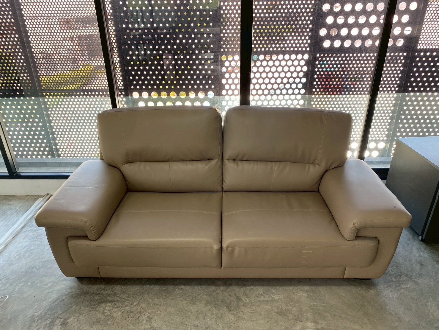 Two-seater sofa with faux leather upholstery, cream brown color, Koncept brand.