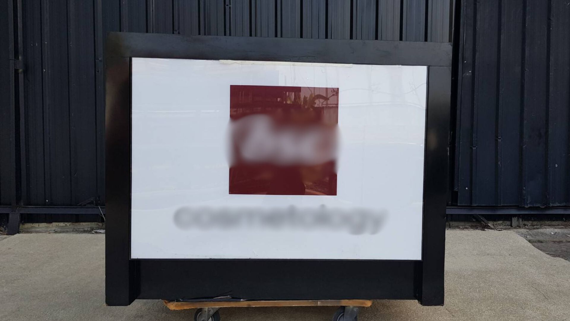 Black wooden dressing table with two sliding doors.