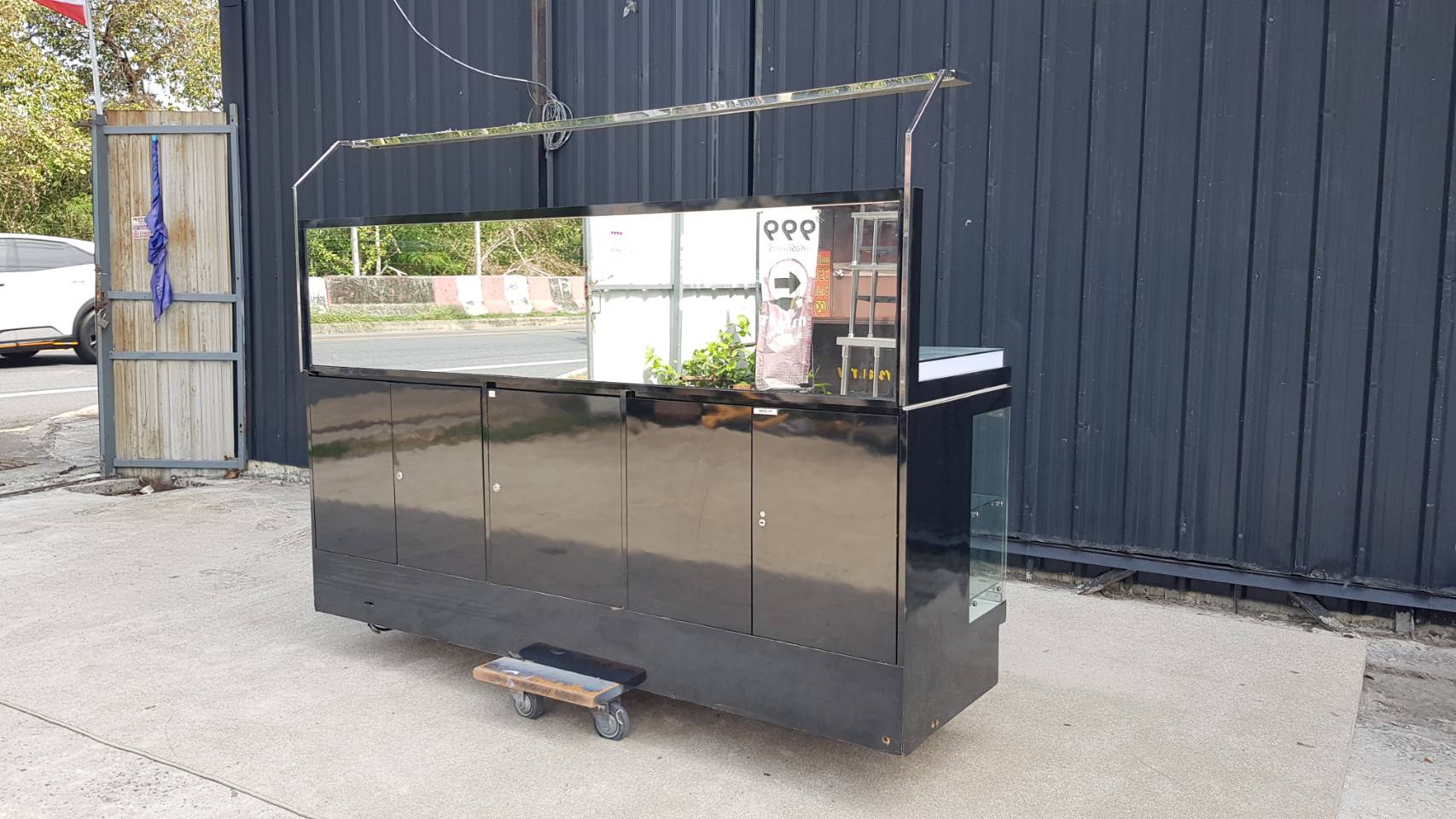 Black display cabinet with two glass doors and five wooden doors.