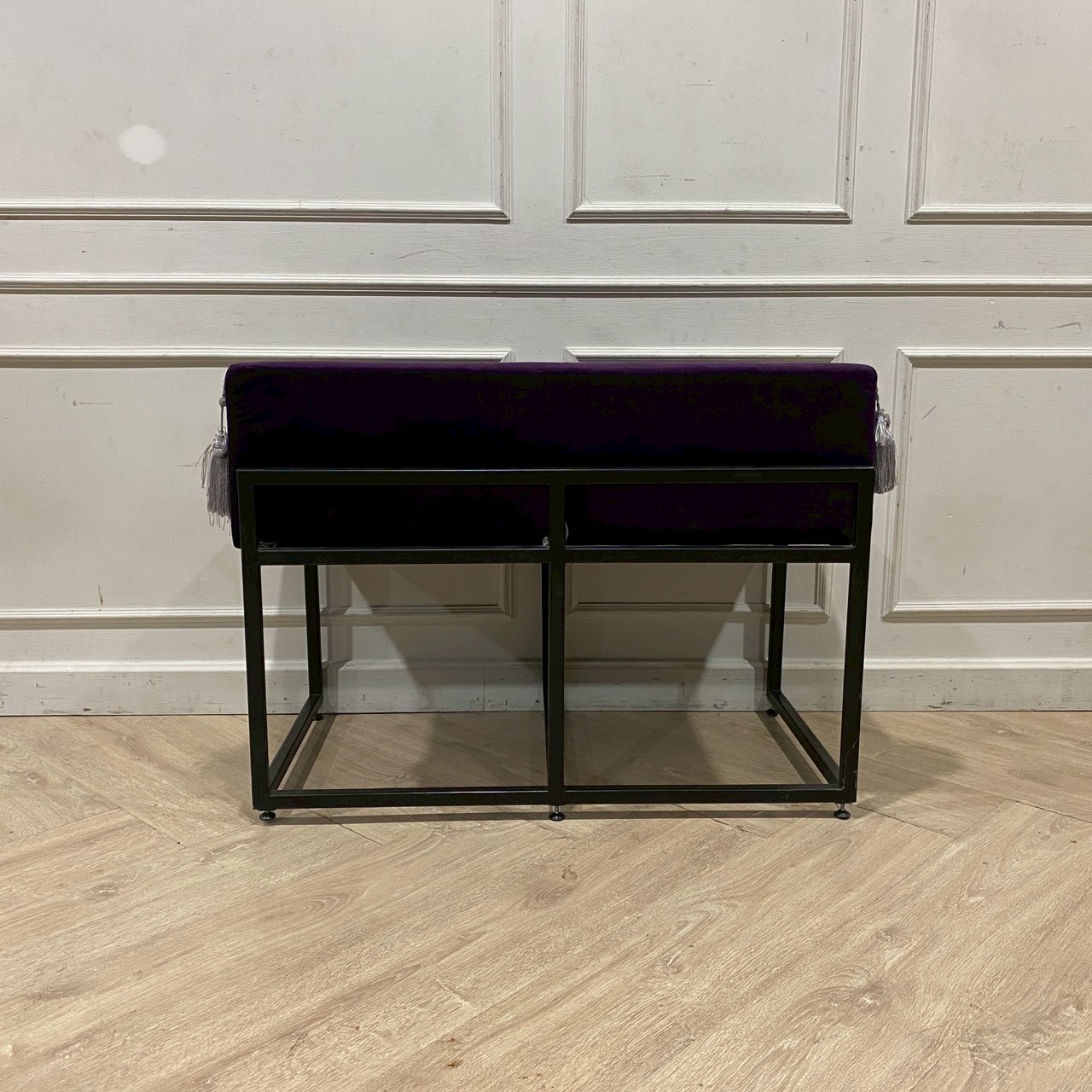 Two-seater chair with steel legs and purple velvet upholstery.