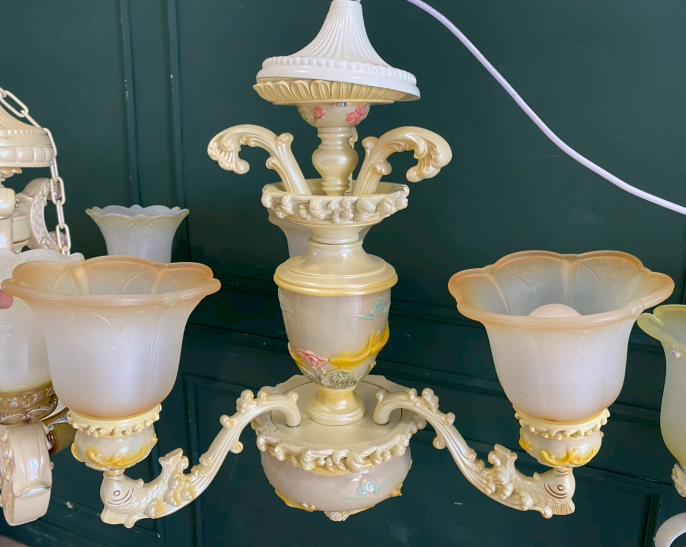 Glass chandelier with fish pattern, cream color.