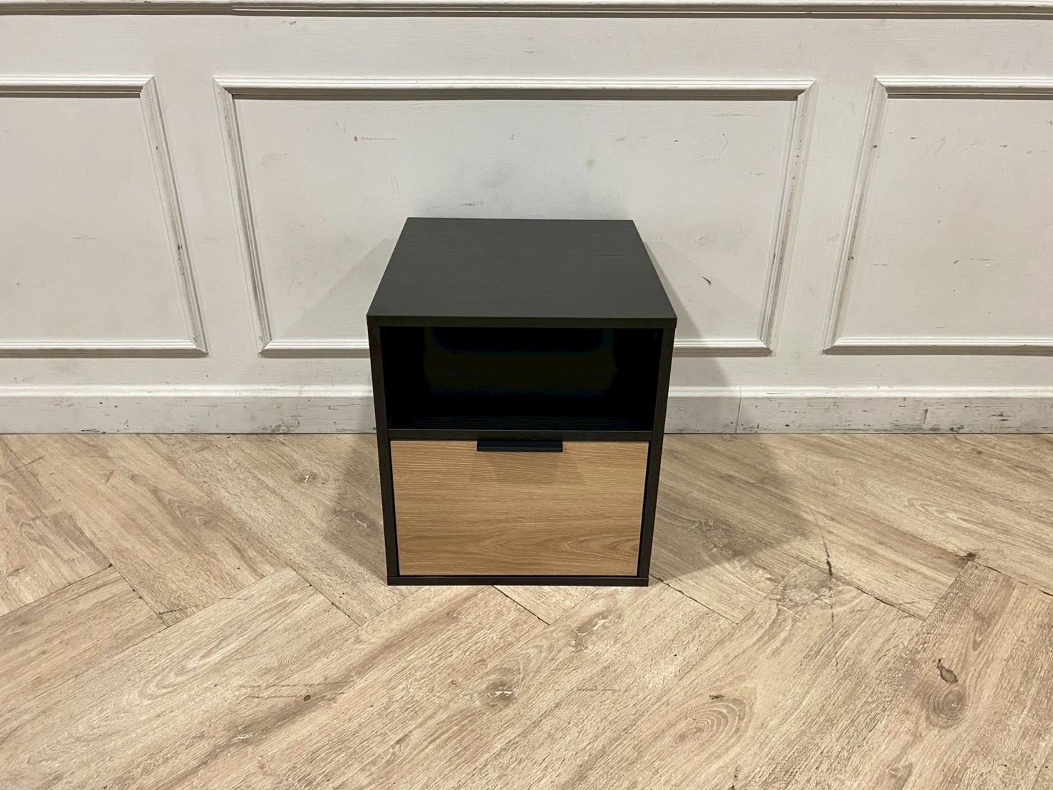 Black wooden cabinet with 1 drawer and 1 storage compartment.