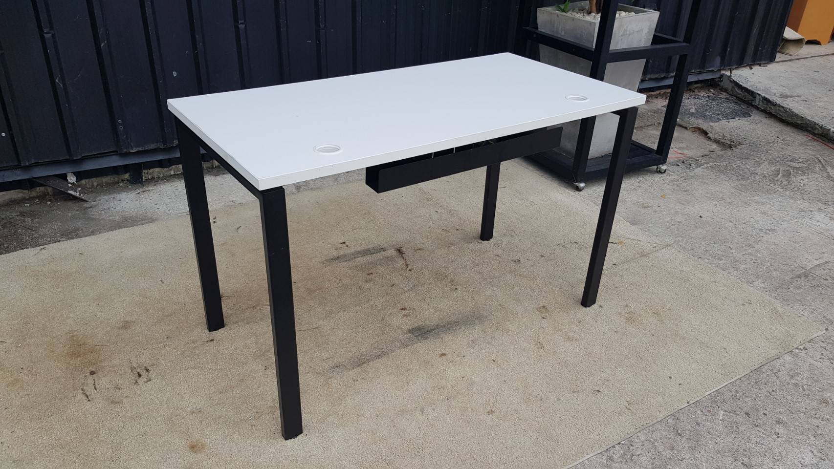 Work desk with white MDF top and black steel legs.