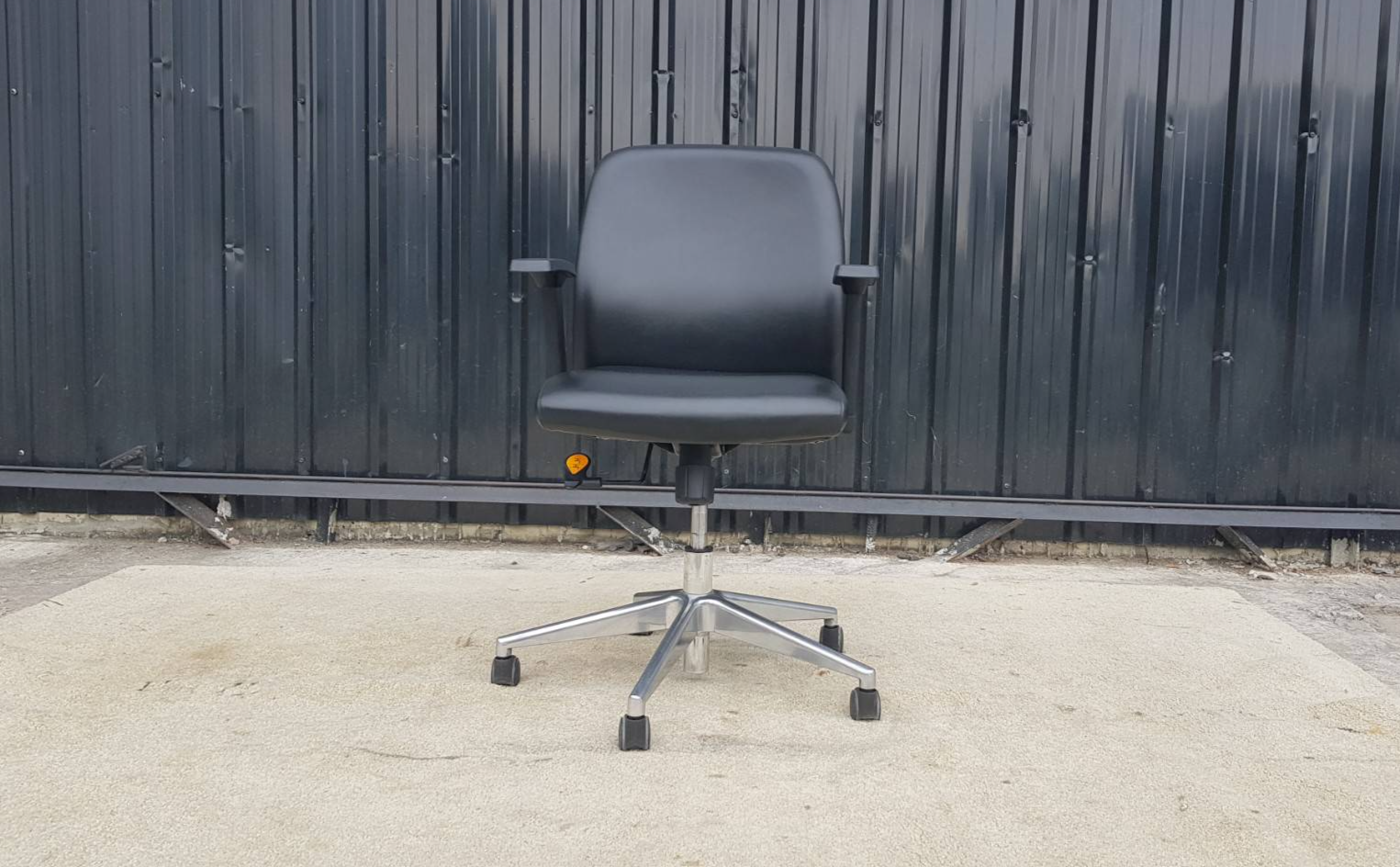 Office chair, steel legs, leather seat, black backrest, Rockworth brand.